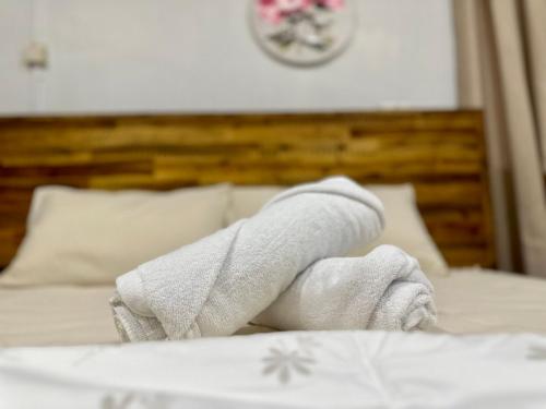 a towel sitting on top of a bed at Mijanna Guesthouse - Johor Bahru in Johor Bahru