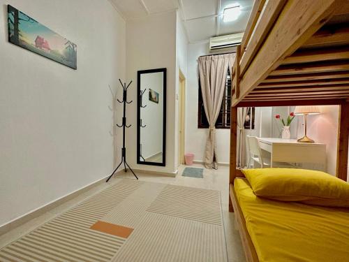 a bedroom with a bed and a table and a mirror at Homestay Mijanna in Johor Bahru