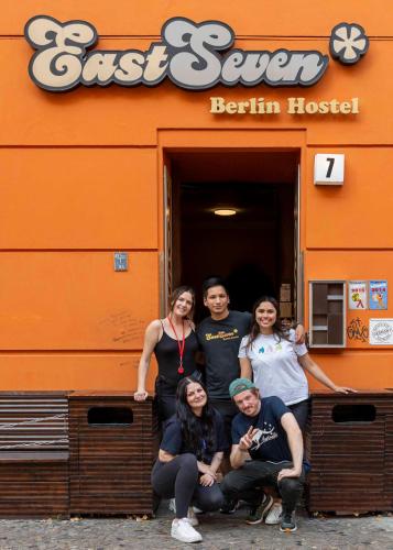 a group of people posing in front of a restaurant at EastSeven Berlin Hostel in Berlin
