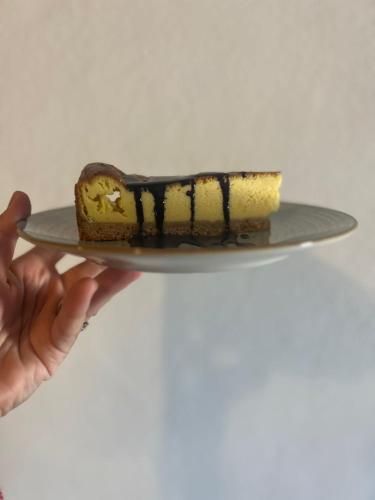 a person holding a piece of cake on a plate at LOCANDA PODERE LE VIGNE in Radda in Chianti