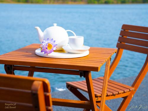 a table with a teapot and cups on it at Bungalow 58 Lake Bennett Darwin in Lake Bennett