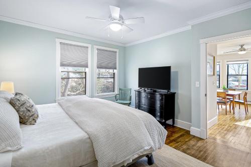a bedroom with a bed and a flat screen tv at Harborwalk Lower and Upper in Camden