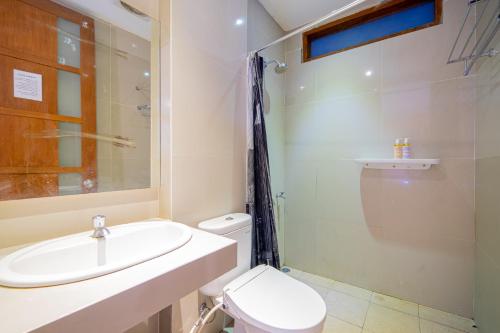La salle de bains est pourvue d'un lavabo, de toilettes et d'une douche. dans l'établissement Payu Hotel Jogja, à Jetis