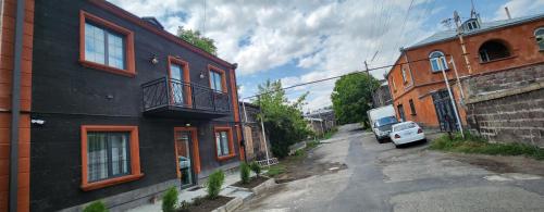 a car parked on a street next to a building at Tatents Toon Guesthouse in Gyumri