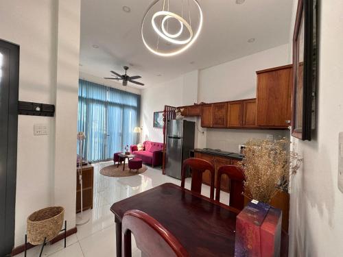 a kitchen and living room with a table and a dining room at MIHA Villa in Cái Răng