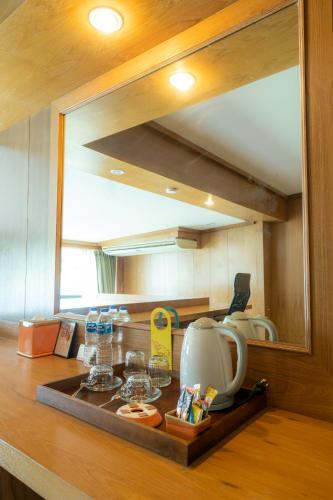 a mirror on a counter in a kitchen at Chabana Resort Bang-tao Beach Phuket- SHA Extra Plus in Bang Tao Beach