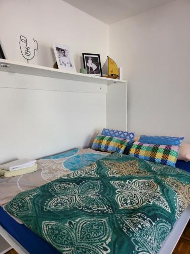 a bedroom with a bed with a colorful comforter at Dolly Apartment Airport in Velika Gorica