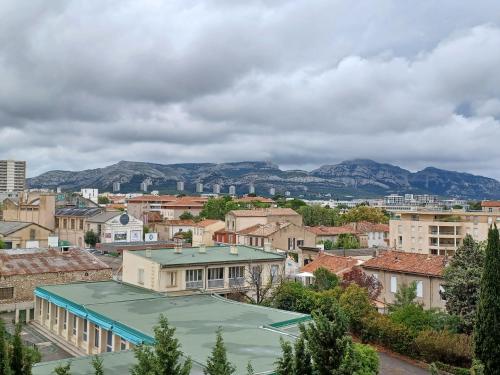 a view of a city with mountains in the background at chambre double proche stade VELODROME in Marseille