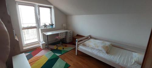 a small room with a bed and a window at House in beautiful suburb of Prague in Dolní Břežany