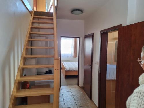 a staircase leading to a room with a bedroom at Trnka in Liptovský Trnovec