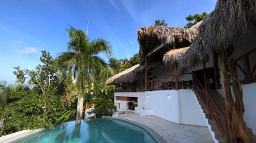 a villa with a swimming pool and a resort at Casa bambu - charming villa in the heart of nature in El Limón