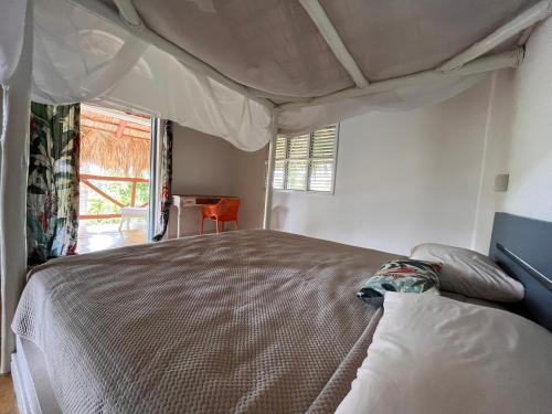 a bedroom with a large bed in a room at Casa bambu - charming villa in the heart of nature in El Limón