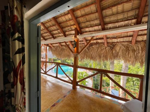a view of a room with a large glass door at Casa bambu - charming villa in the heart of nature in El Limón