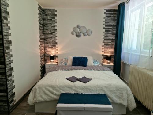 a bedroom with a large bed and two lamps at Penzion Stavař in Vrbno pod Pradědem