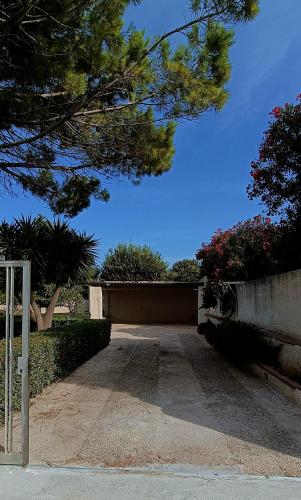 a parking lot with trees and a blue sky at VersoSUD in Marsala