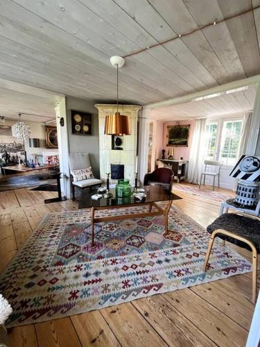 a living room with a rug on a wooden floor at Gränna Grandeur Stay in Style in Gränna
