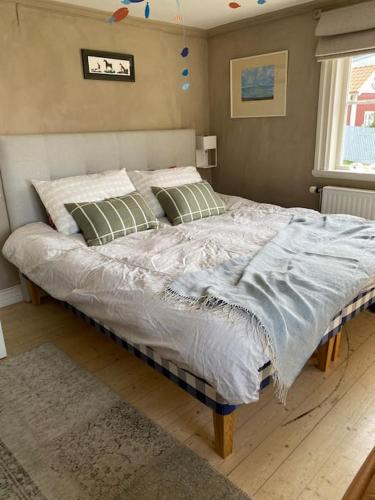 a bedroom with a large bed with a blue comforter at Gränna Grandeur Stay in Style in Gränna