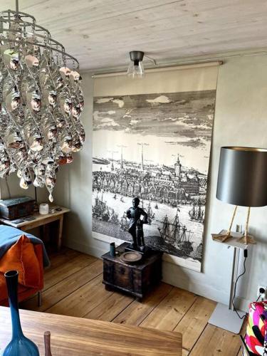 a living room with a painting on the wall at Gränna Grandeur Stay in Style in Gränna