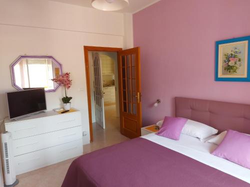 a bedroom with a bed and a television in it at Relax al mare in Borgio Verezzi