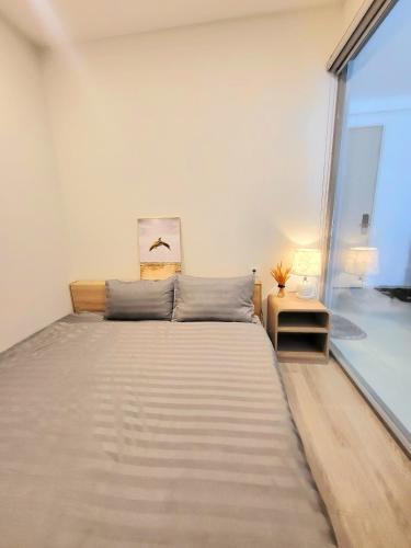 Ένα ή περισσότερα κρεβάτια σε δωμάτιο στο Milan Homestay - The Song Vung Tau Apartment