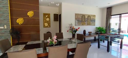 a dining room with a table and chairs at Sila Thai Pool Villa2 in Ao Nang Beach