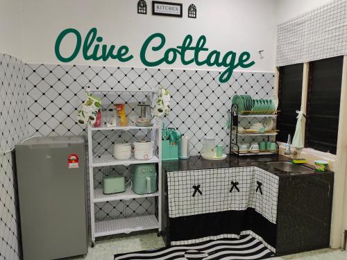 a kitchen with a wine exchange sign on the wall at Olive Cottage in Kampong Ru Lima
