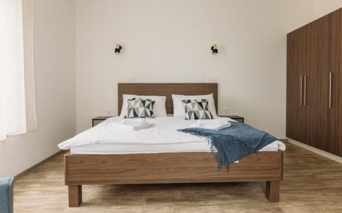 a bedroom with a large bed with a wooden headboard at Hiša na Ravnah in Pišece