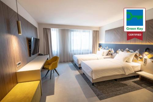 Ένα ή περισσότερα κρεβάτια σε δωμάτιο στο Austria Trend Hotel Ljubljana