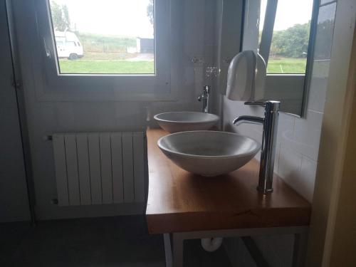 a bathroom with a bowl sink and a window at Langre Wayve House in Langre
