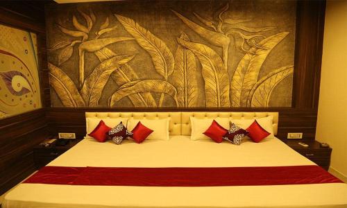 a bedroom with a large bed with red pillows at KINGSWAY HOTEL AND RESTAURANT Ajmer Dargah 350 Meter in Ajmer