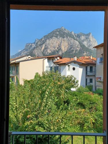 a view of a mountain from a window at La Casa del Colibrì in Lecco