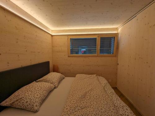 Habitación pequeña con cama y ventana en TinyHouse - (D)ein Ferienhaus en Schellenberg