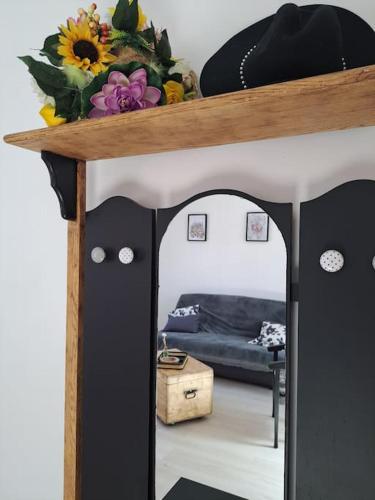 a living room with a table with flowers on it at appartement la Gravelinoise in Gravelines