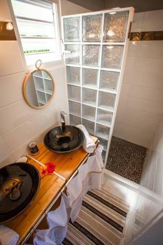 a small bathroom with a sink and a shower at Vwe moun Bay in Deshaies