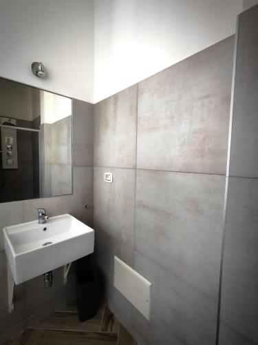 a bathroom with a sink and a mirror at The House of the Waves in Brindisi