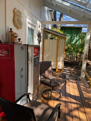 a patio with chairs and a refrigerator and a table at 150-year-old Lincolnville cottage 3bedroom 2bath in St. Augustine