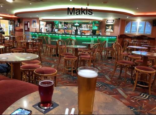 a bar with tables and chairs and two glasses of beer at Jans chalet south shore Bridlington in Bessingby