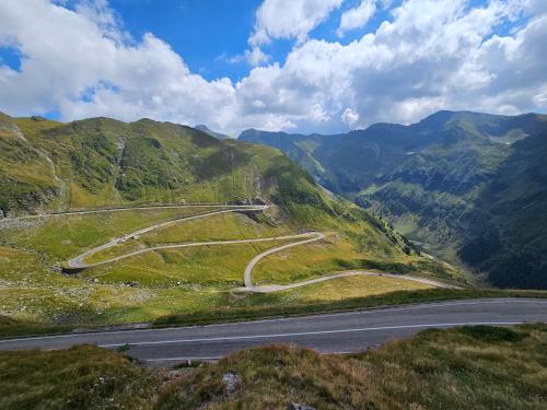 a winding road on the side of a mountain at Casa Oaspeti Transfagarasan in Cîrţişoara