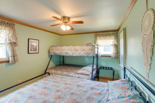 a bedroom with two bunk beds and a ceiling fan at Retro Green Bay Home Steps to Lambeau Field! in Green Bay