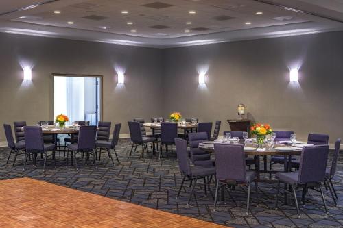 a banquet room with tables and chairs and a large window at Courtyard by Marriott Boston Billerica Bedford in Billerica