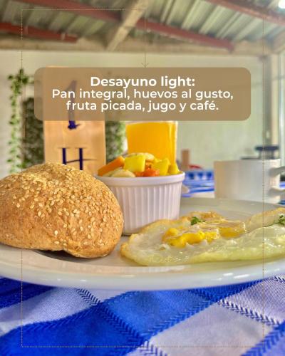 a plate of food with a sandwich on a table at HIDALGO HOTEL in Palmira