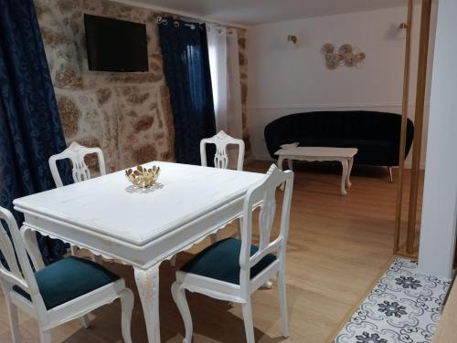 a white table and chairs in a living room at Casinhas do Miga in Santa Comba Dão