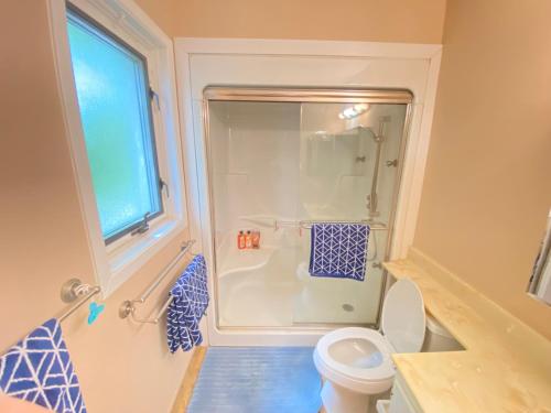 a bathroom with a shower and a toilet and a window at 41 Huntsmill Blvd in Toronto