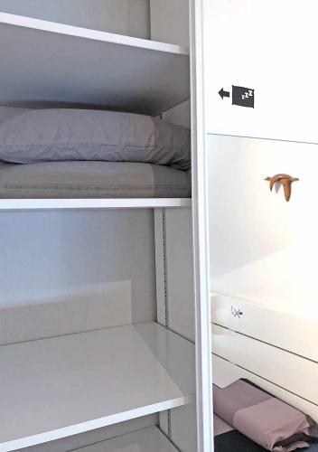 a white closet with a bed in it at Reims Saint-Remi in Reims