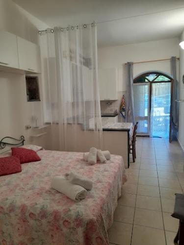 a bedroom with a bed with two towels on it at La Calla Rossa in Levanto