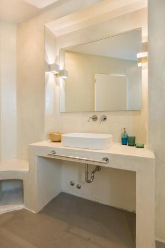 a white bathroom with a sink and a mirror at Summera villas Paros in Chrissi Akti