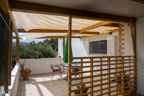 a patio with awning and a table and chairs at Lydia Guest House in Palekastron