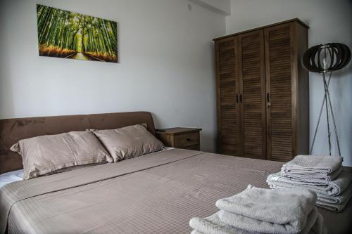 a bedroom with a bed with towels on it at Lena_Lux in Jagodina