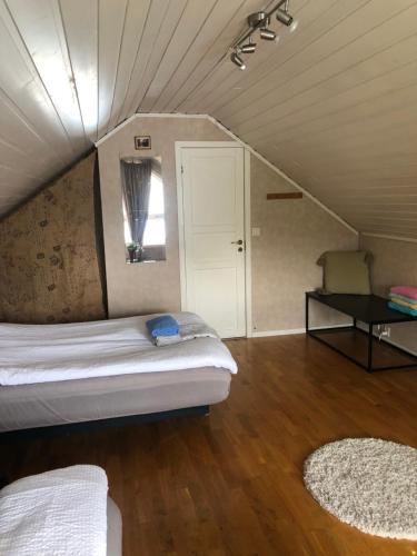 a bedroom with a bed and a table in a attic at Bamse in Bodø