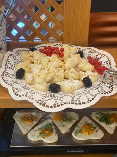 a plate of food on a table with appetizers at Pension Rucksackpeter in Hohenbrugg an der Raab